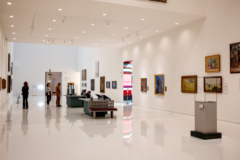 Visitors browsing paintings in an art gallery