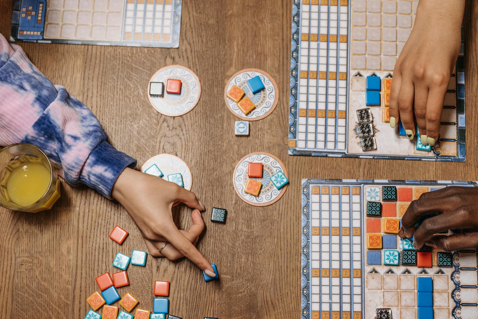 Friends enjoying board games at a cozy cafe table