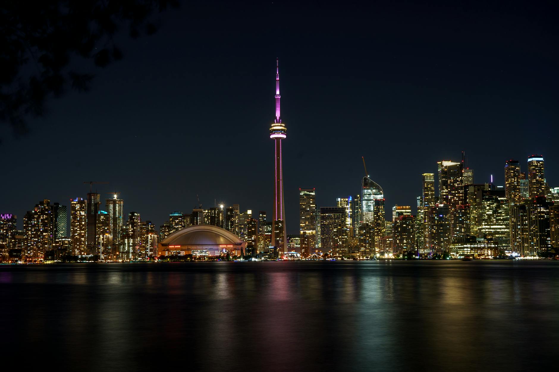 CN Tower at night with lights against Toronto skyline