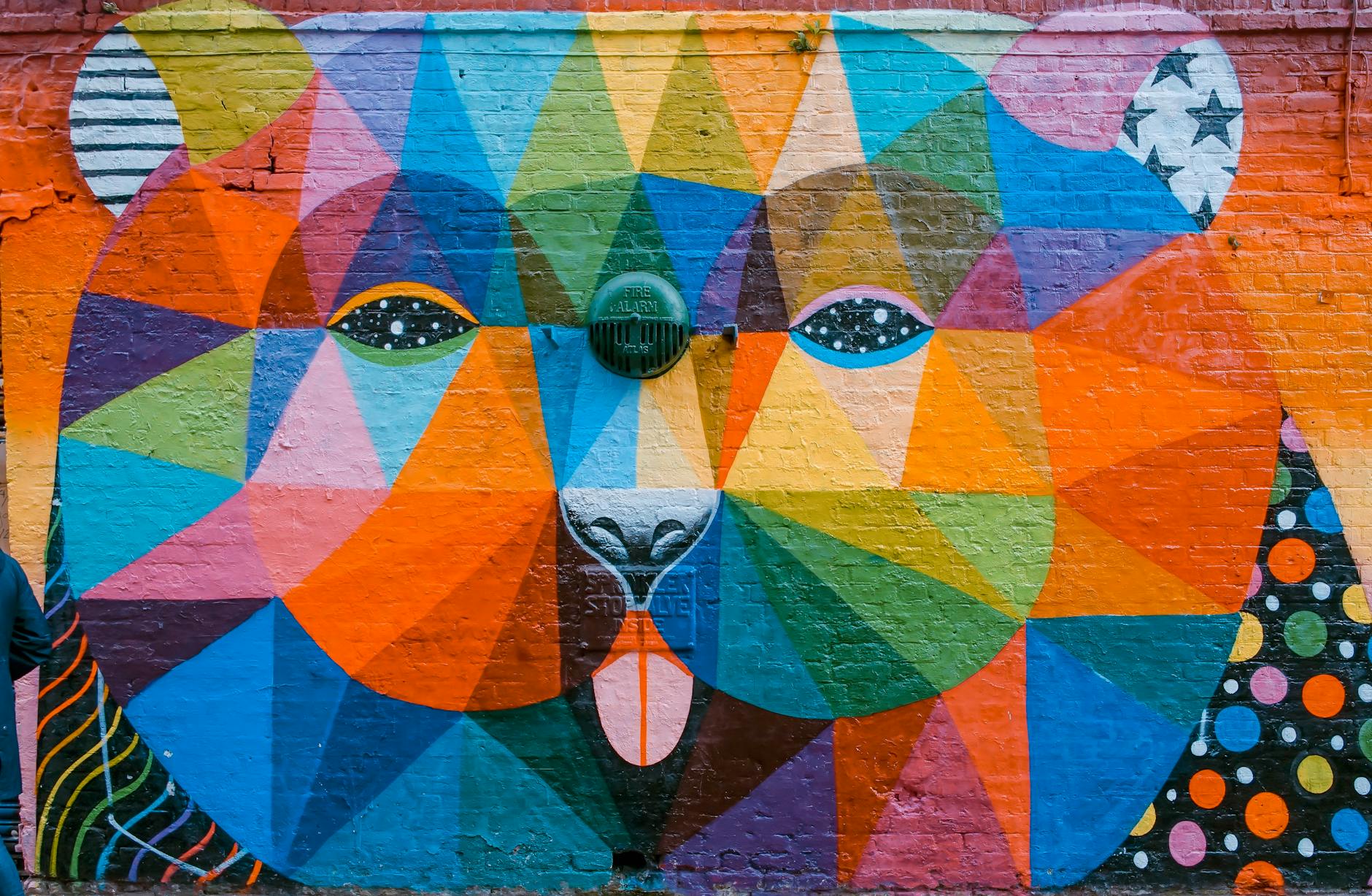 Vibrant geometric street art mural on brick wall