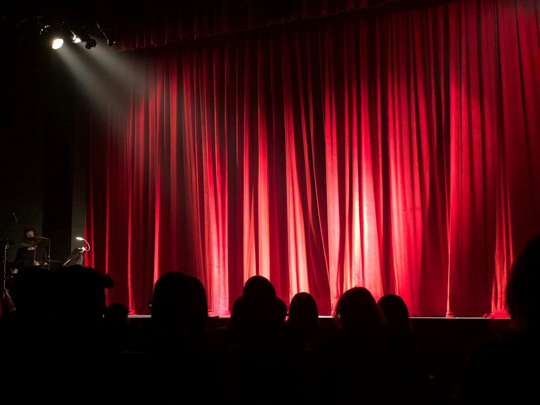 Comedy show performer on stage under bright spotlights