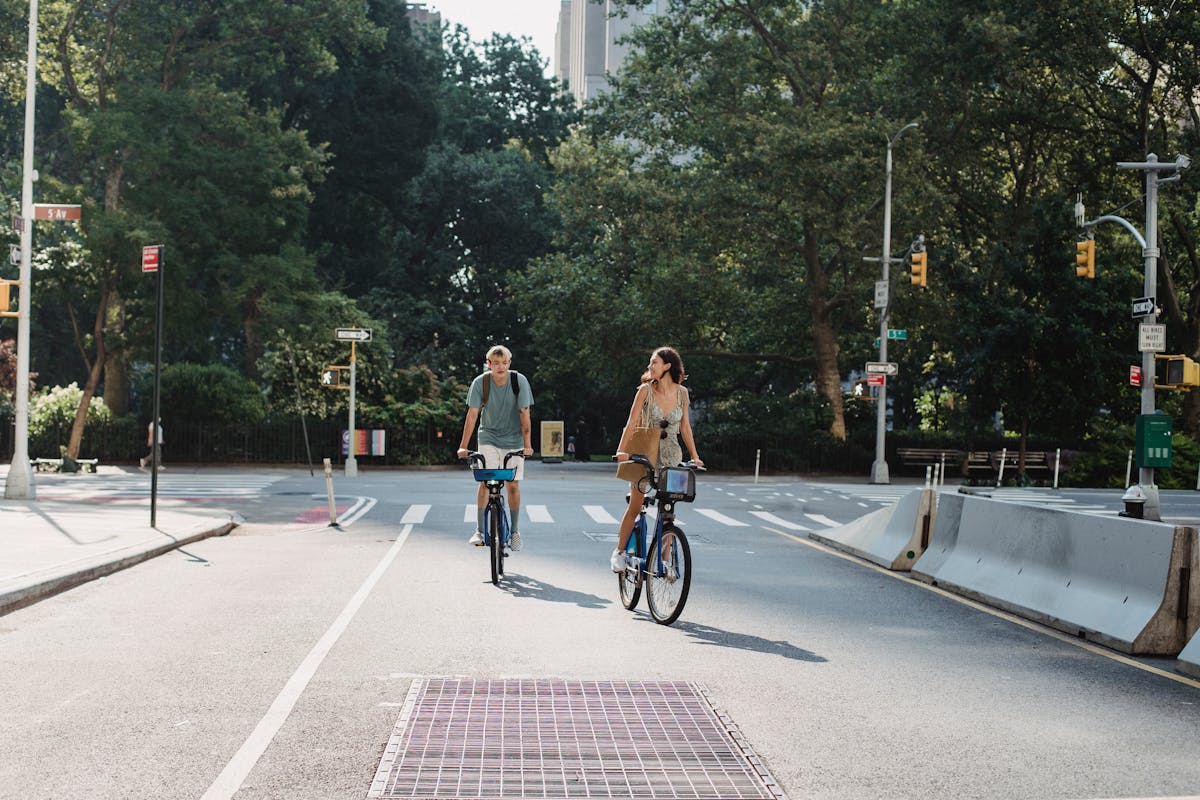 Couple riding bikes along a scenic path