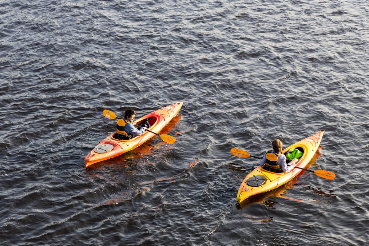 Couple kayaking together on a peaceful lake