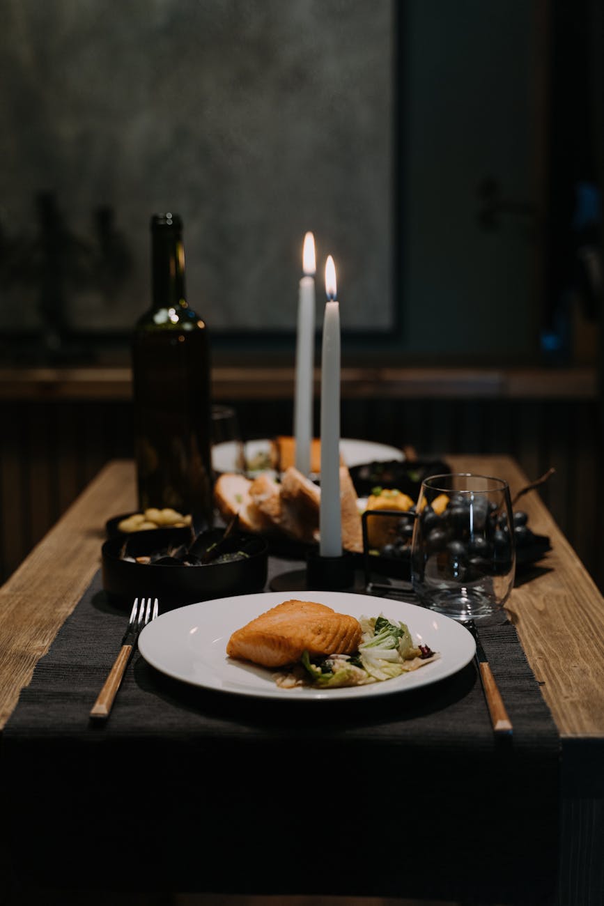 Romantic candlelit dinner in a dark atmospheric restaurant