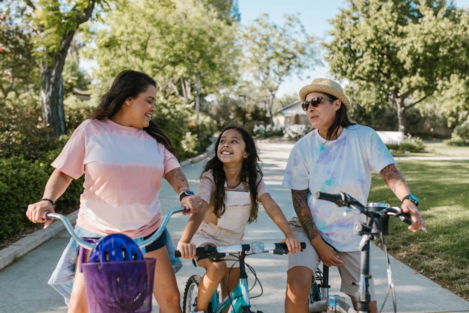 Family enjoying a sunny day riding bicycles together in a park