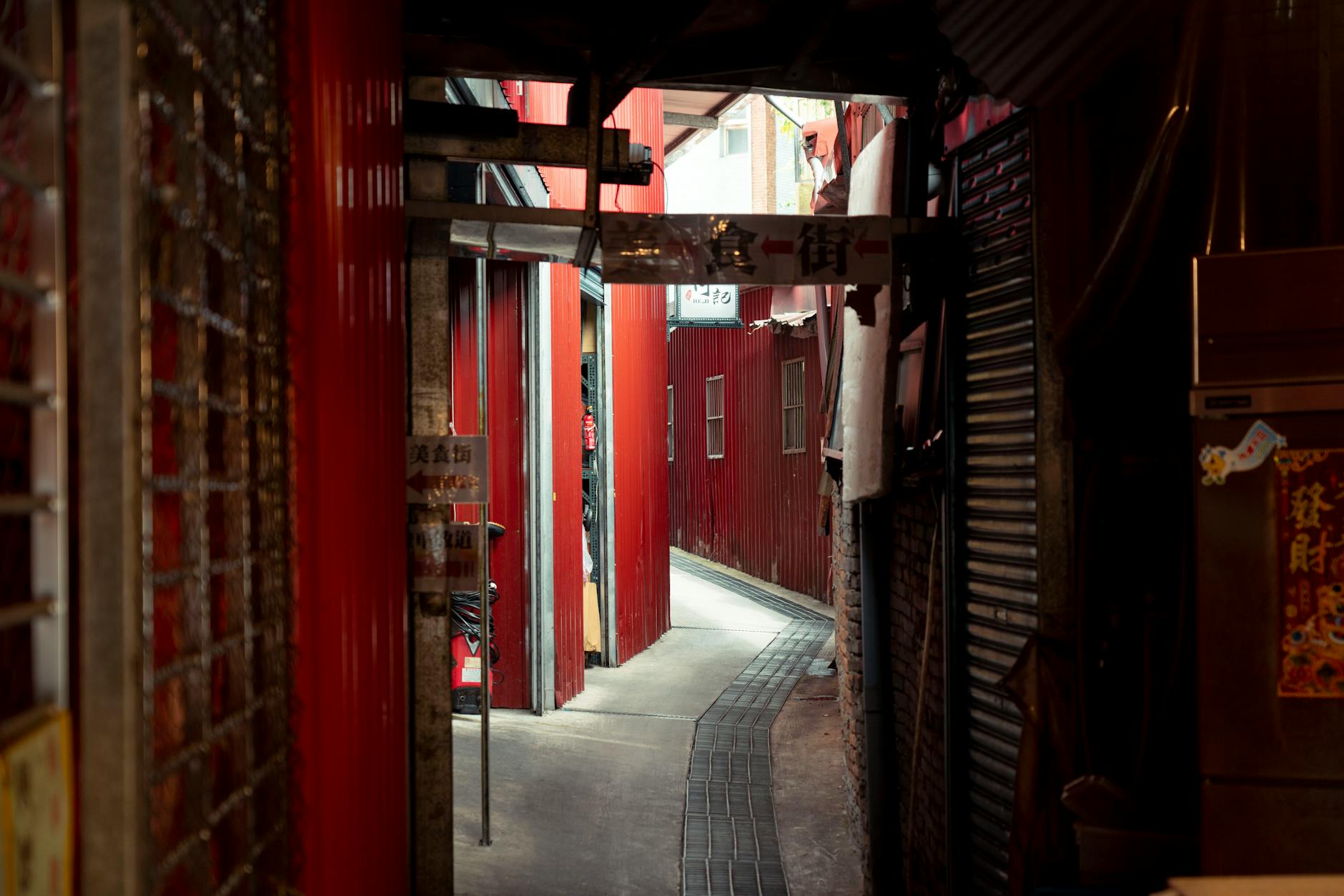 Mysterious narrow alleyway with vibrant red walls