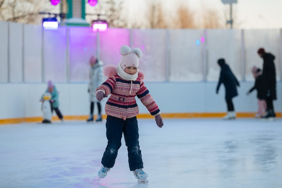Young girl enjoying ice skating at an outdoor rink bundled up for winter