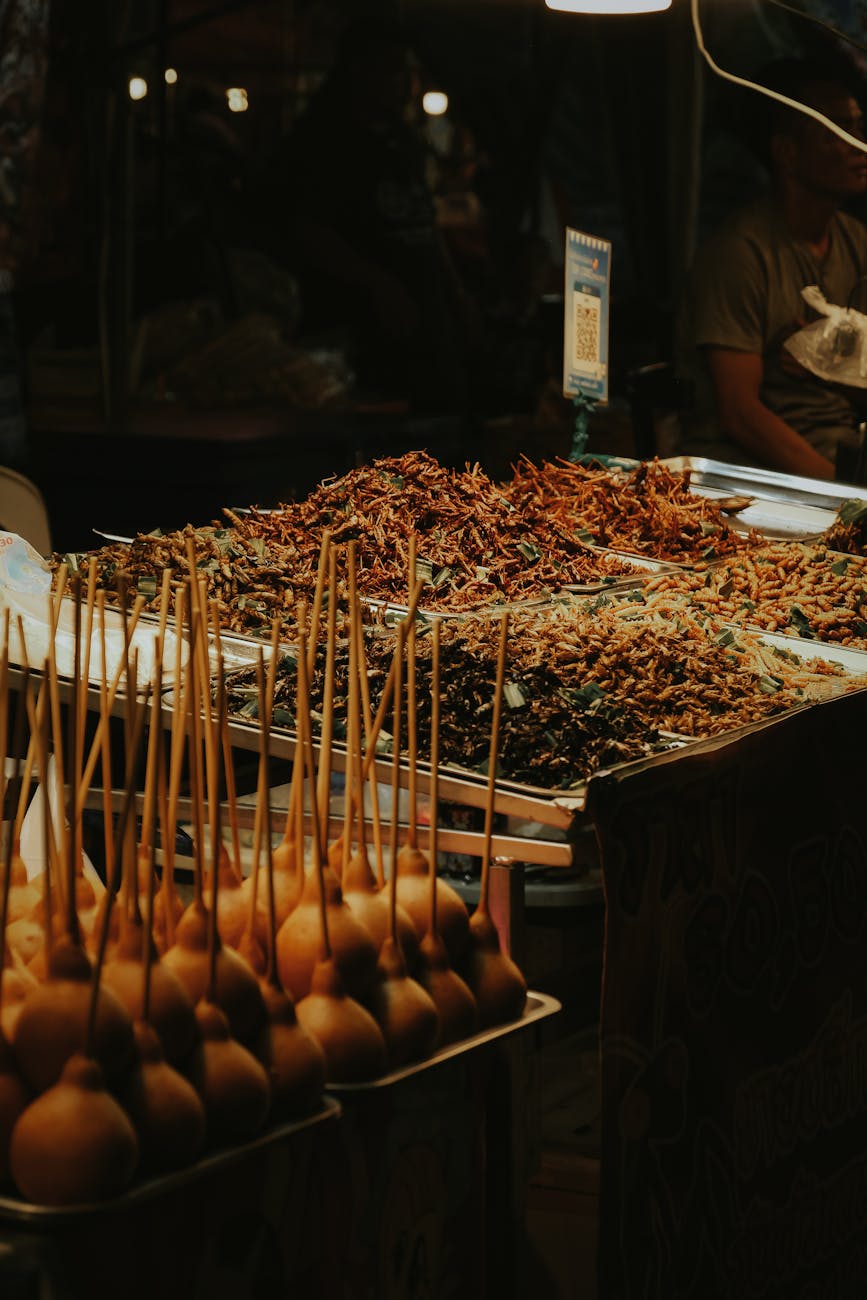 Bustling night market with food vendors and glowing lanterns