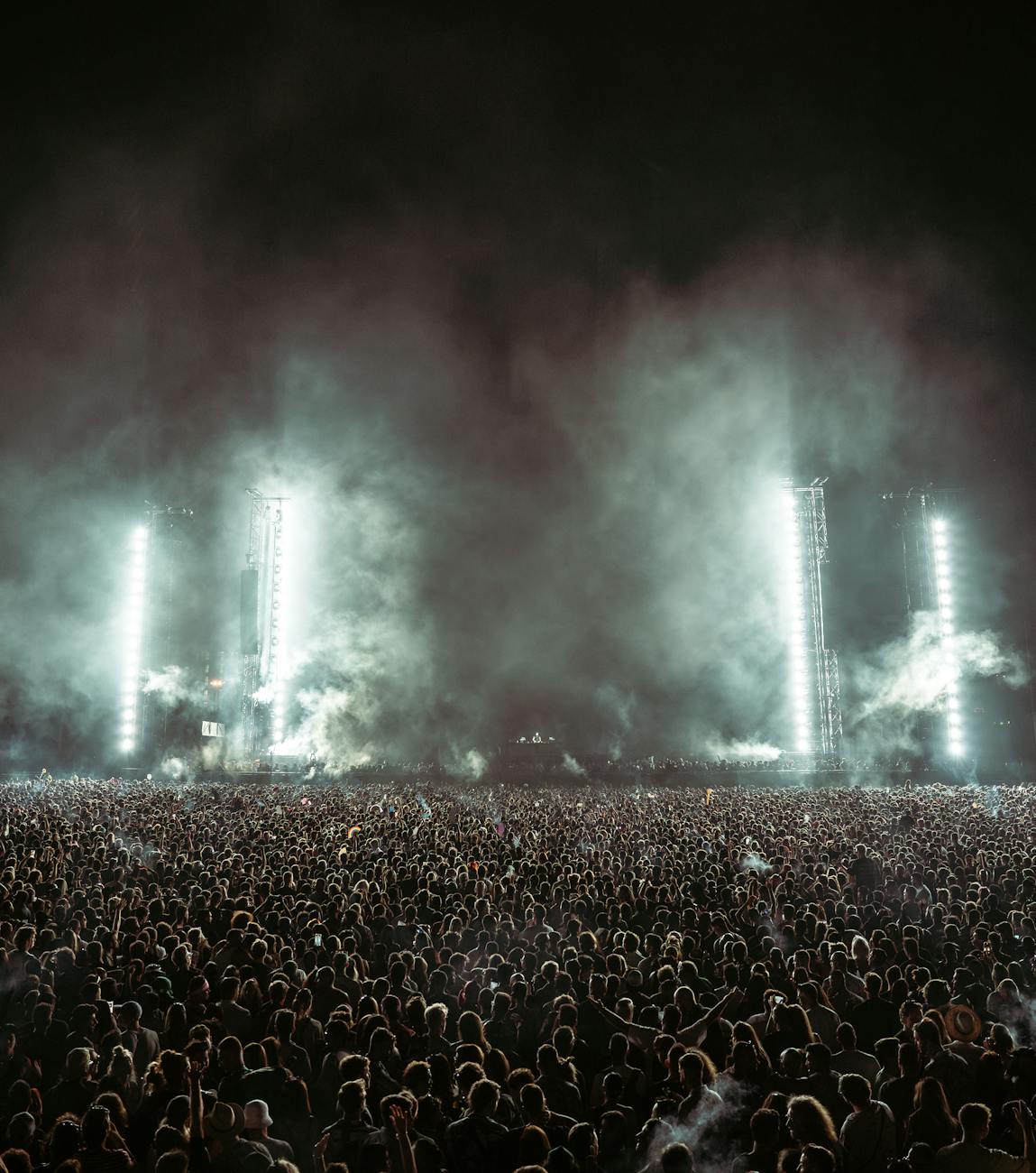 Crowd enjoying a music festival under stage lights
