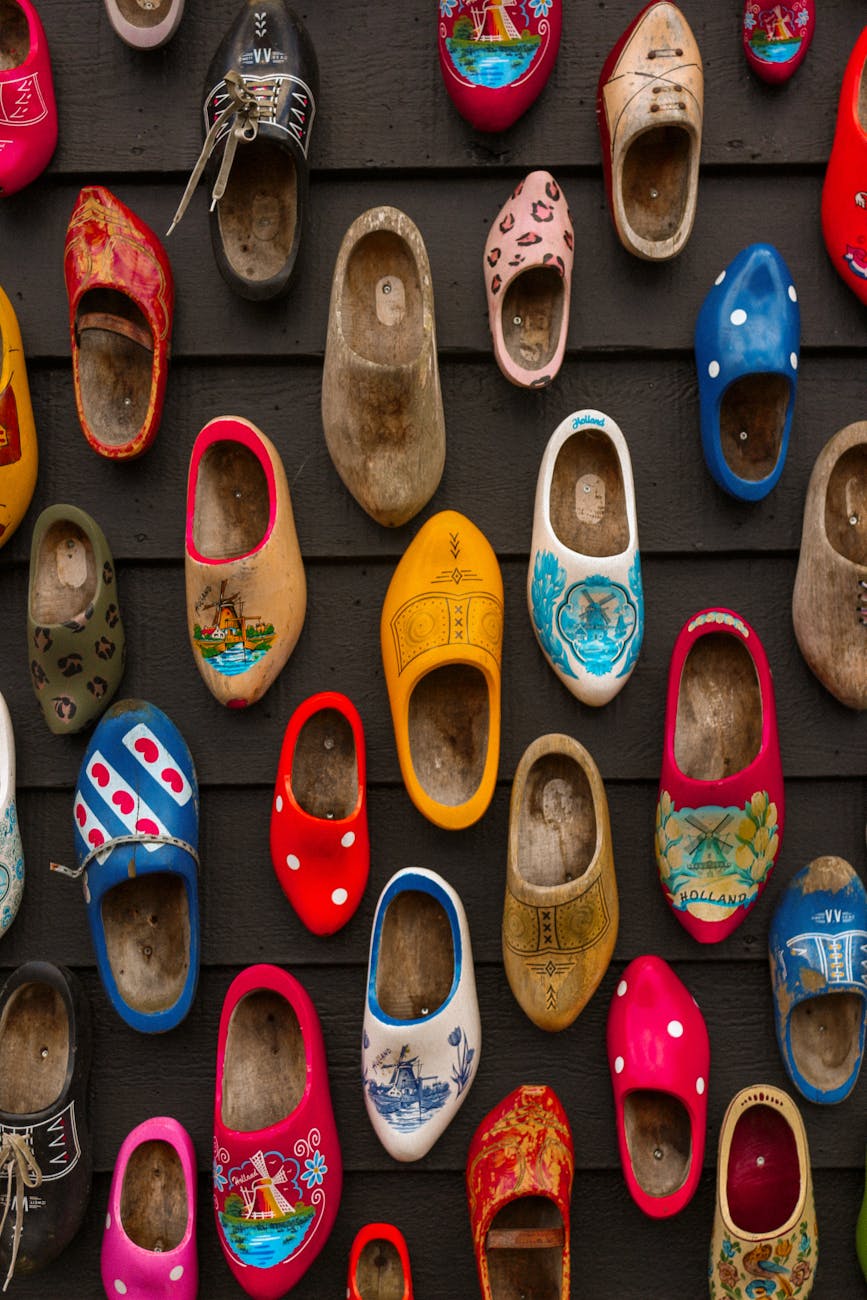 Colorful collection of shoes displayed on a wall in a museum