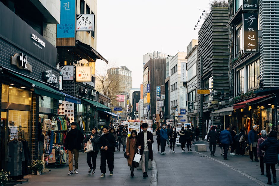 Busy urban street shopping district with pedestrians browsing stores in Toronto