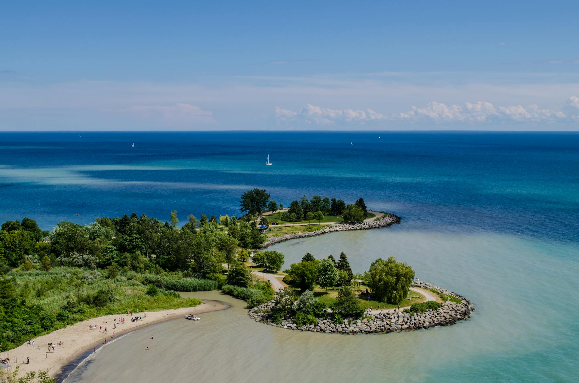 Toronto Islands beach with lake and CN Tower in distance