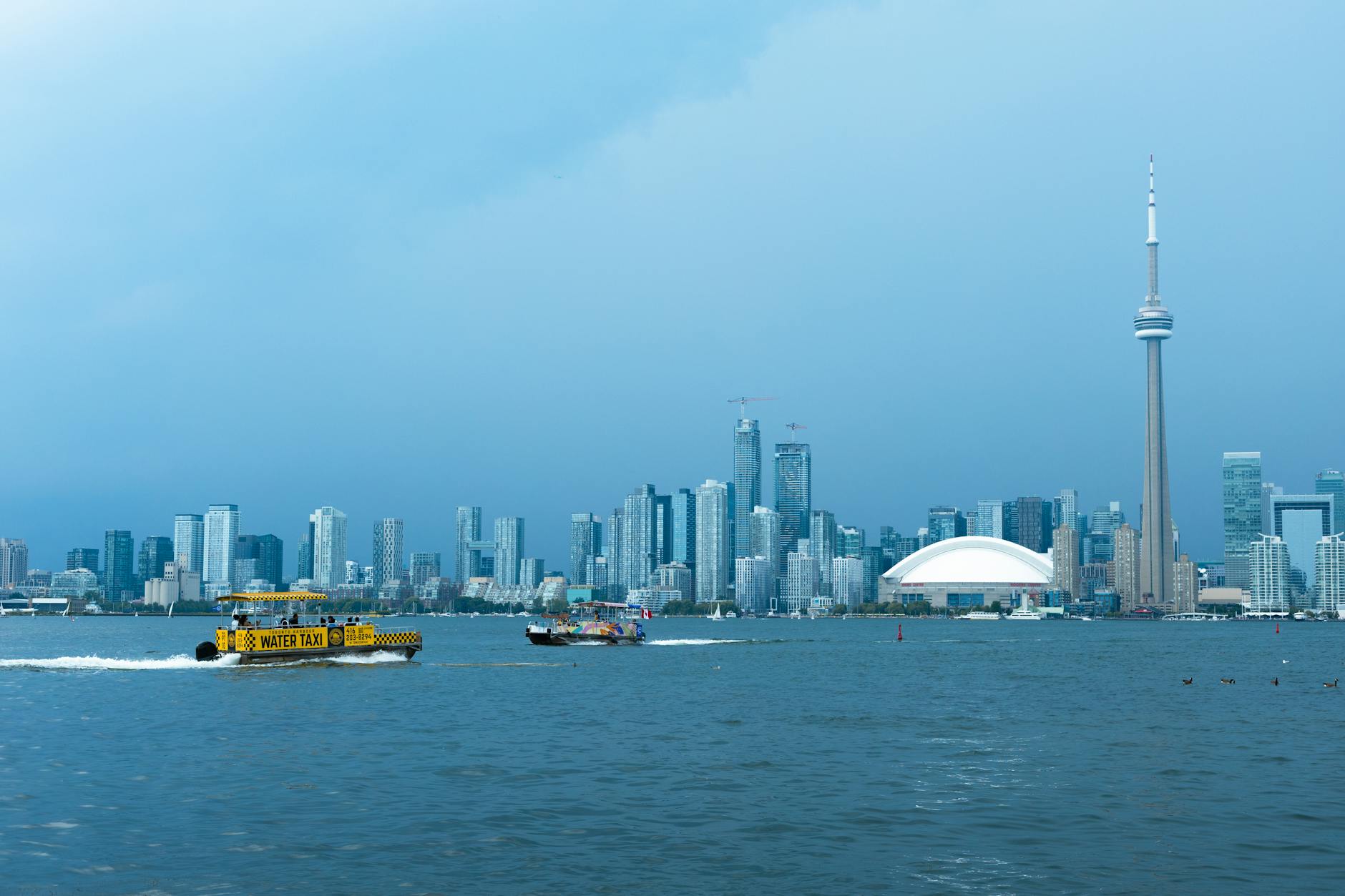 Toronto skyline with CN Tower and water taxi on Lake Ontario