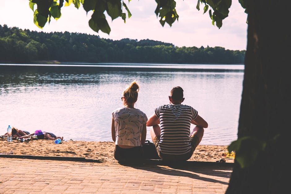 Couple relaxing by the lake on a summer day