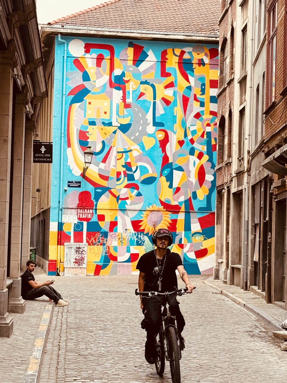 Vibrant mural in alley with cyclist