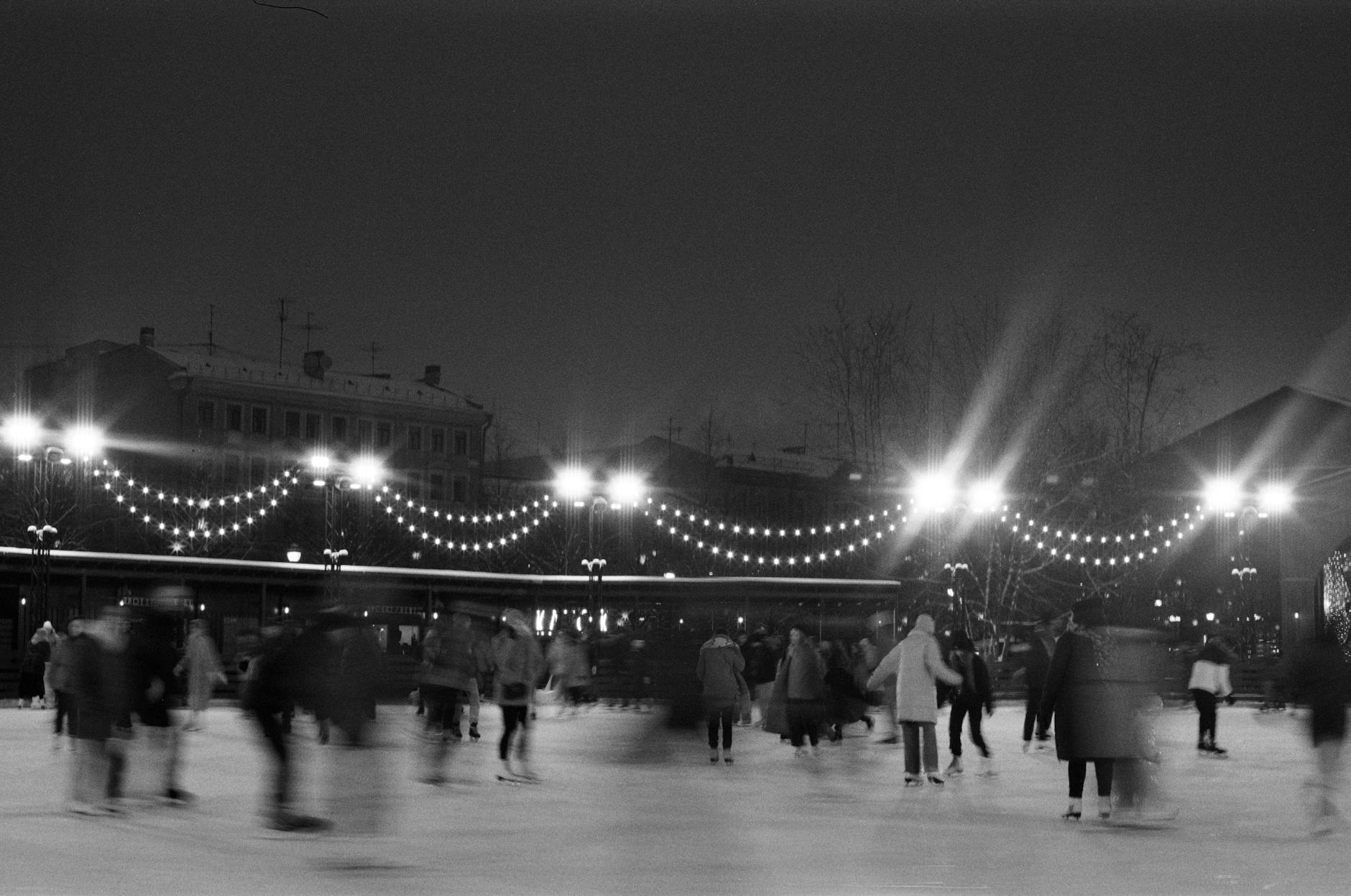 Ice skating Toronto night lights skaters glowing arches winter atmosphere
