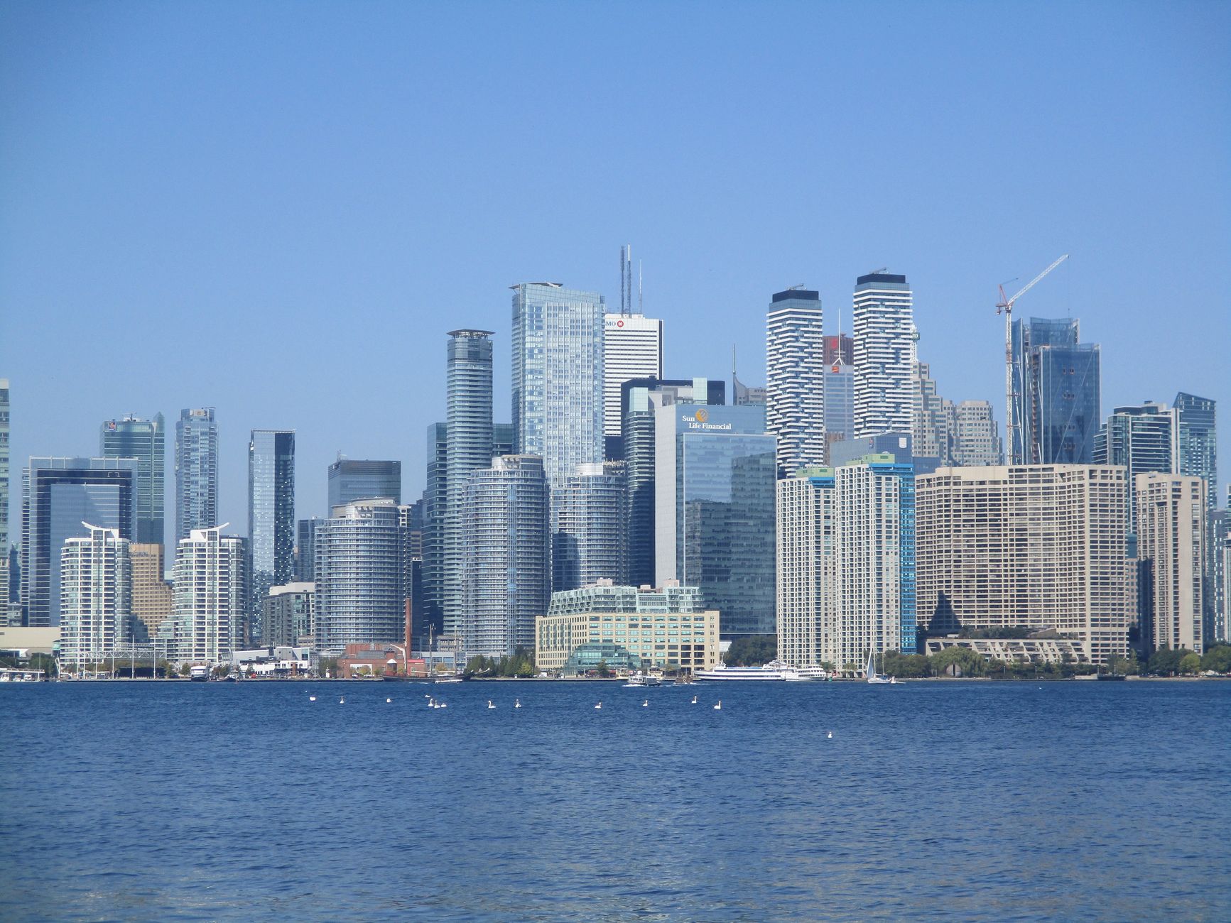 Downtown towers seen low across the harbour at dusk, the view that opens 2 days in Toronto