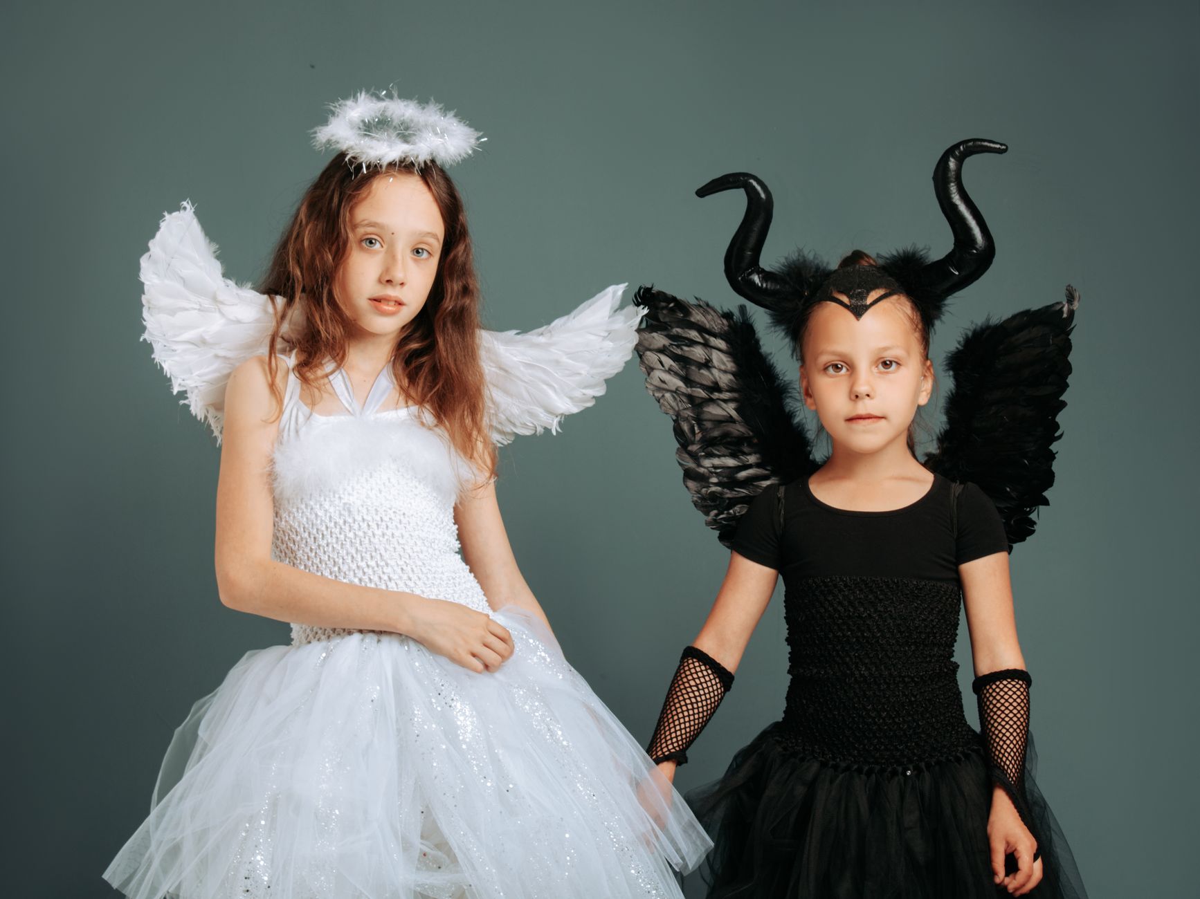 Two people dressed as an angel and a devil for a Halloween party