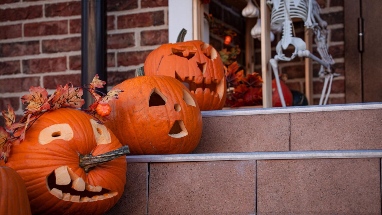 jack-o-lanterns glowing on porch