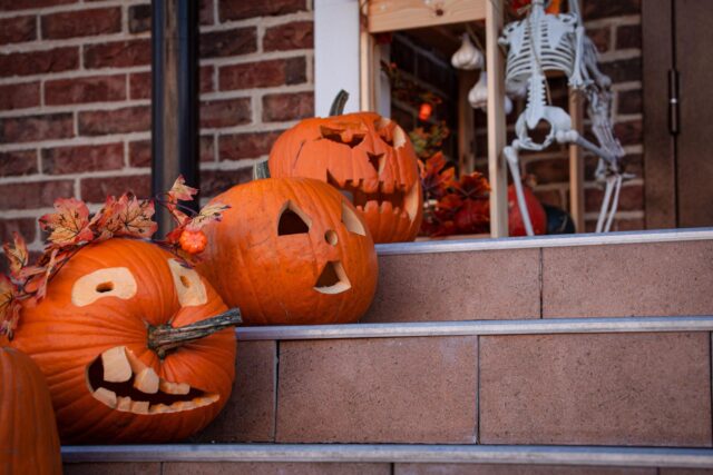 jack-o-lanterns glowing on porch