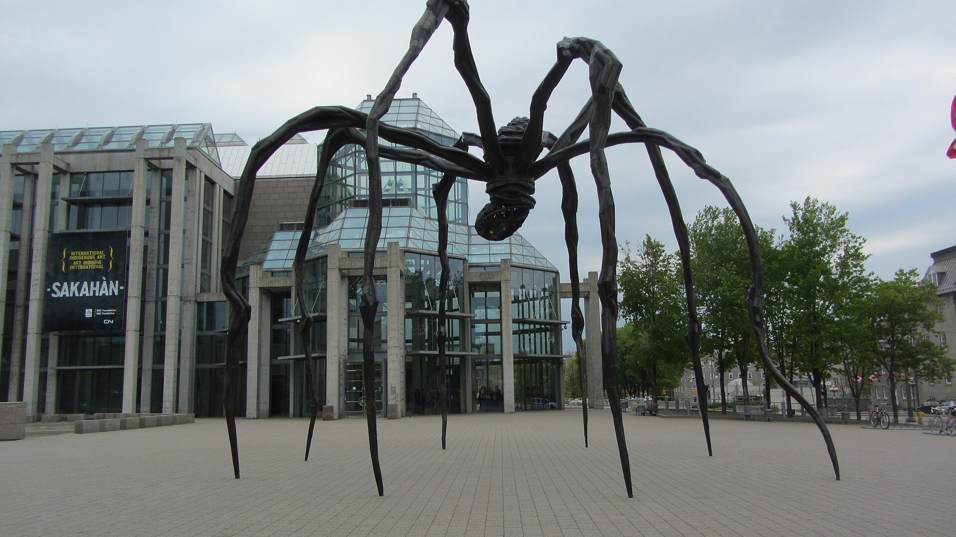 Louise Bourgeois's giant bronze spider sculpture Maman standing on the plaza in front of the glass entrance of the National Gallery of Canada in Ottawa