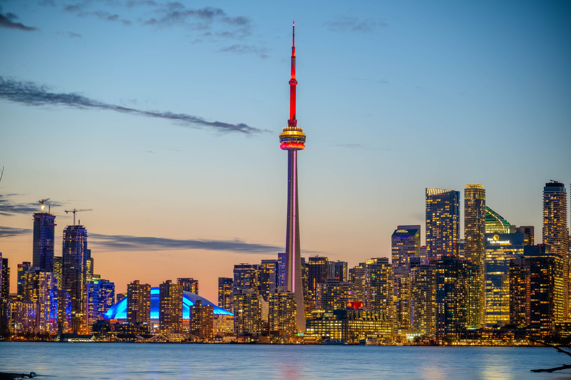 Toronto skyline and the CN Tower across the water at dusk, the city you get one day in Toronto to see