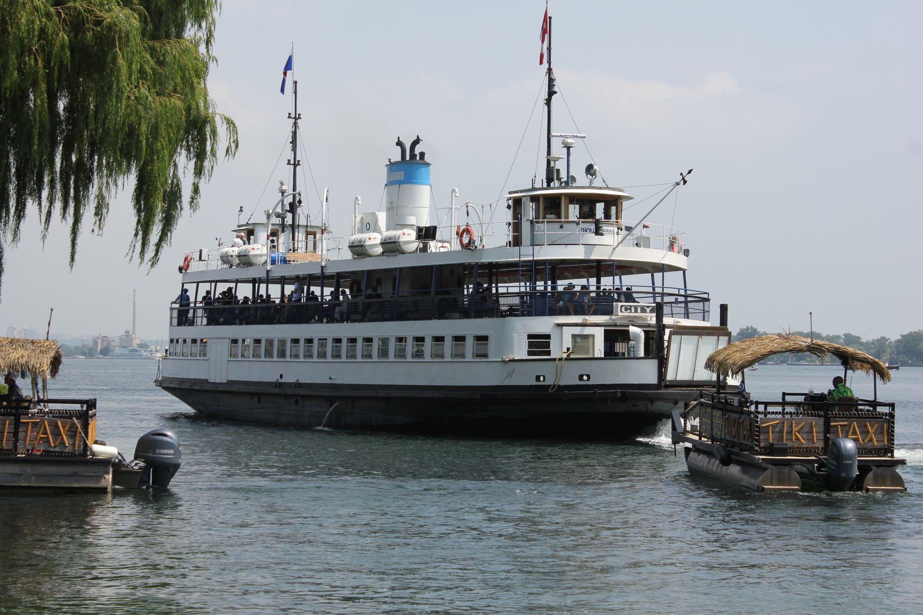 Passenger ferry crossing open water toward a city waterfront