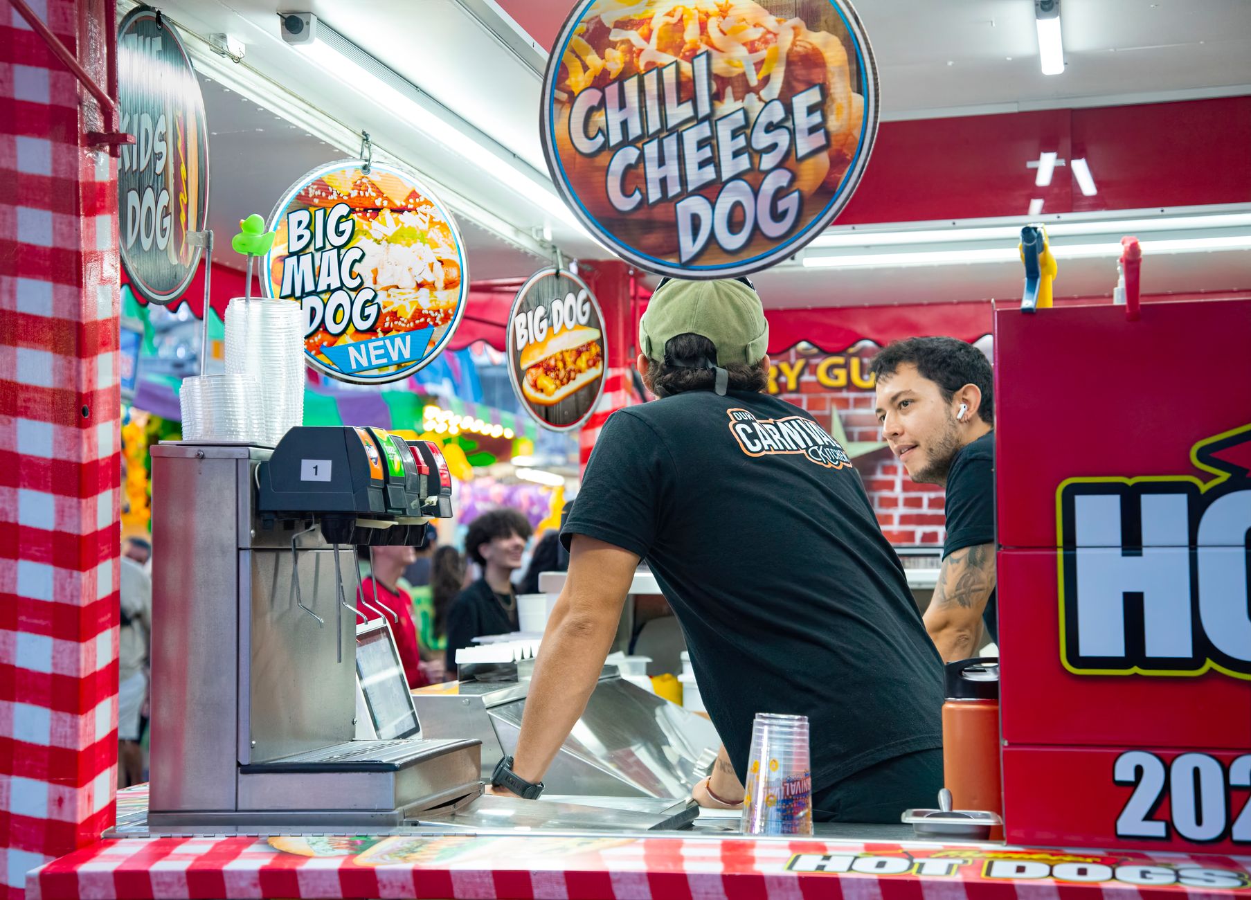 Ballpark concession stand serving hot dogs and fries under warm lights