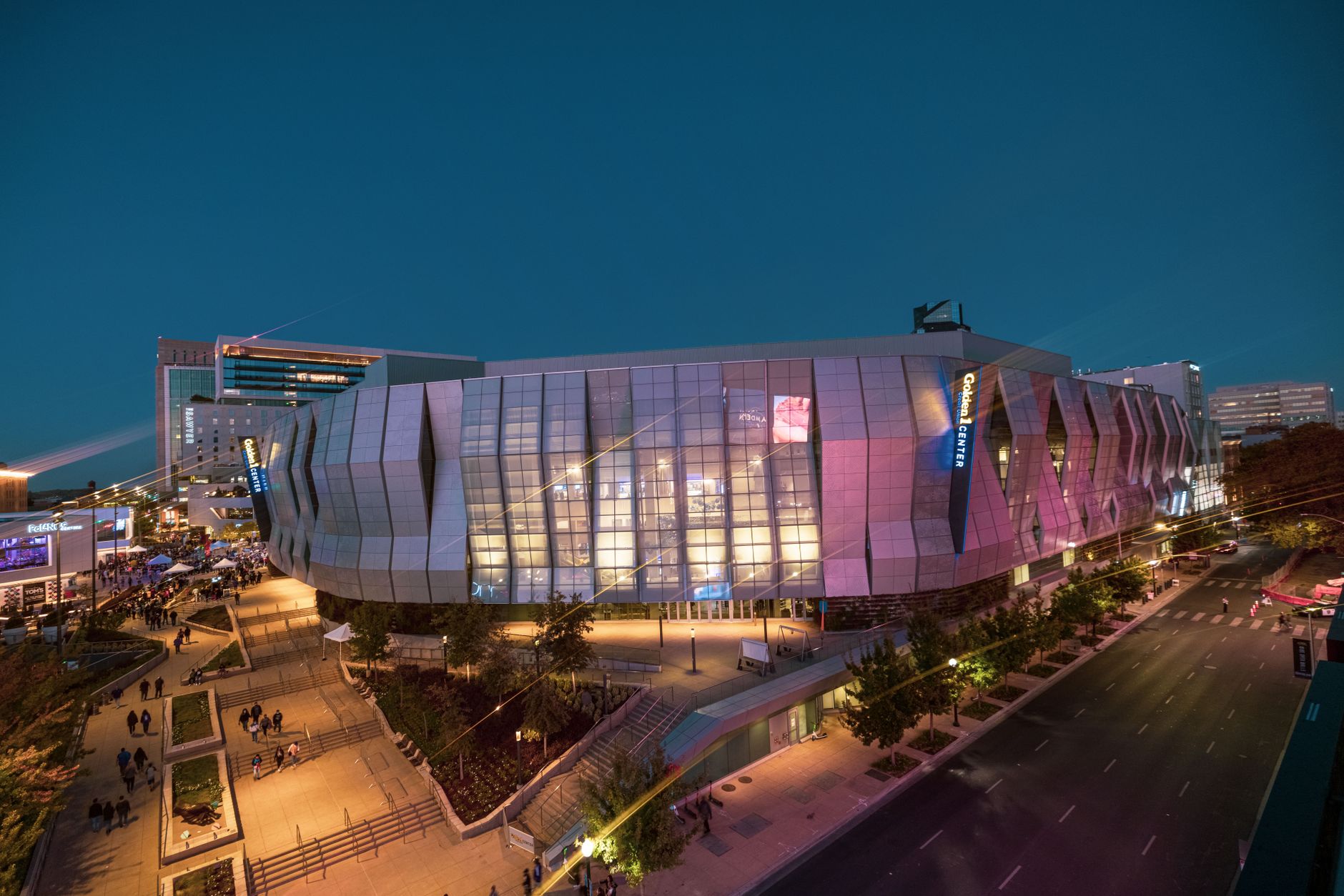 A modern downtown arena lit up on a game night