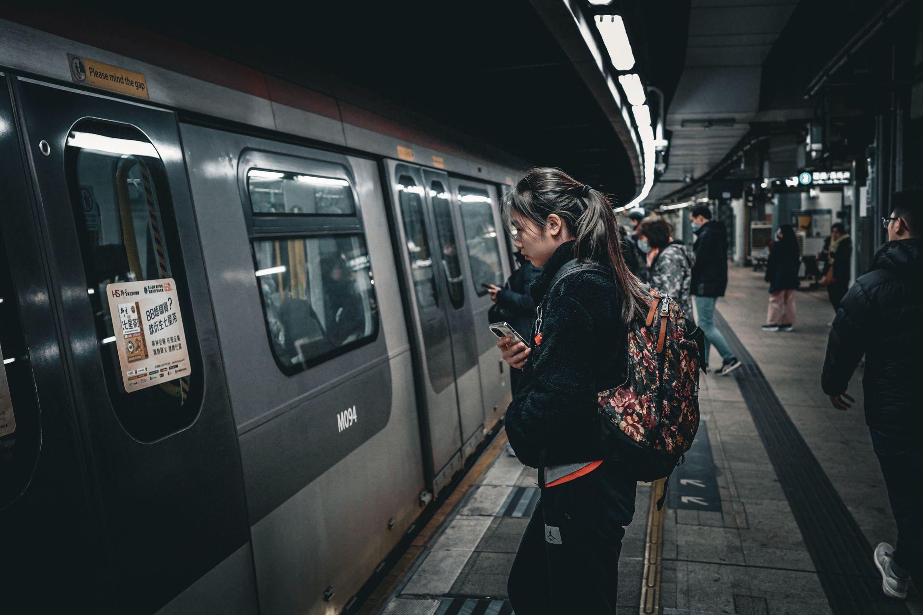 Commuters on a busy underground subway platform at rush hour