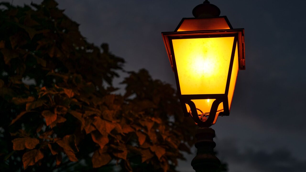 brass lantern wet cobbled street