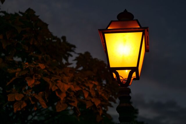 brass lantern wet cobbled street